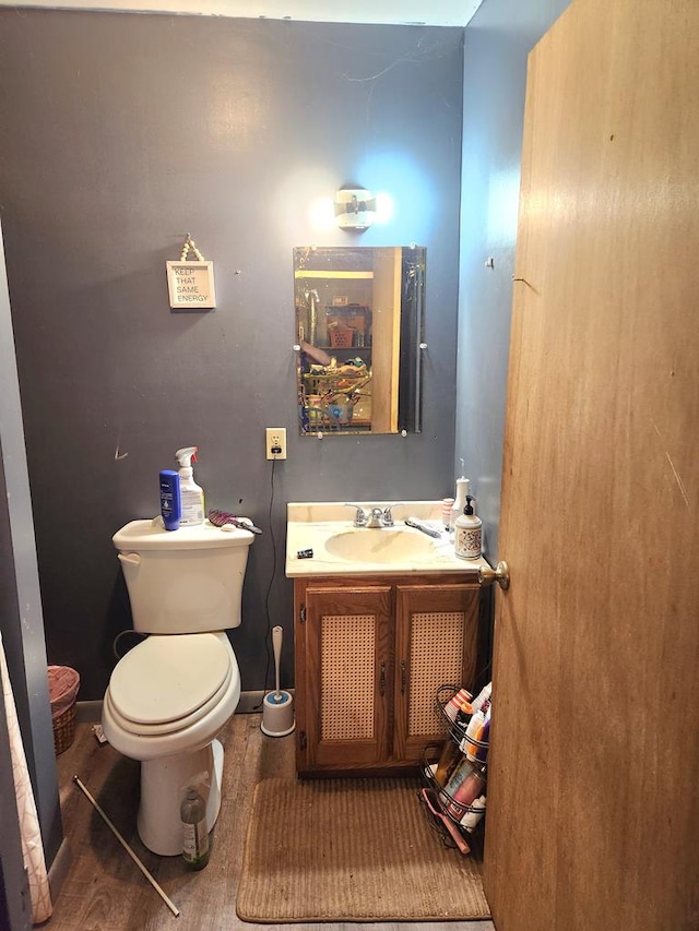 bathroom featuring vanity, hardwood / wood-style floors, and toilet