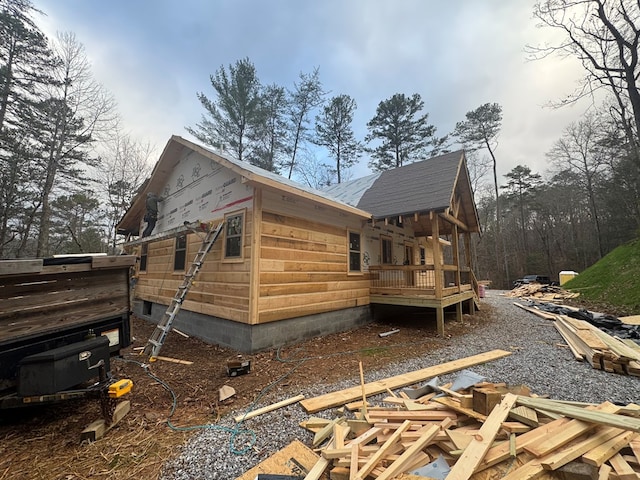 view of side of property with a wooden deck