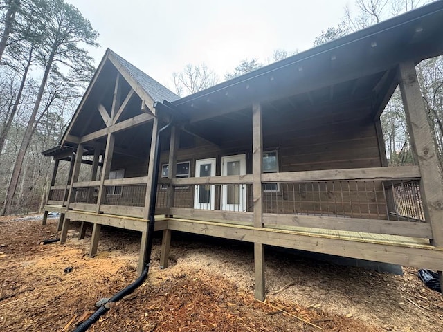 view of property exterior with a shingled roof