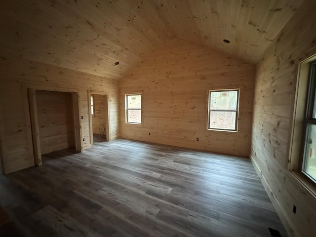 bonus room featuring lofted ceiling, wood ceiling, a wealth of natural light, and wood finished floors