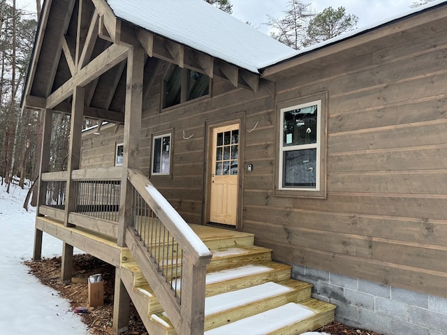 view of snow covered property entrance