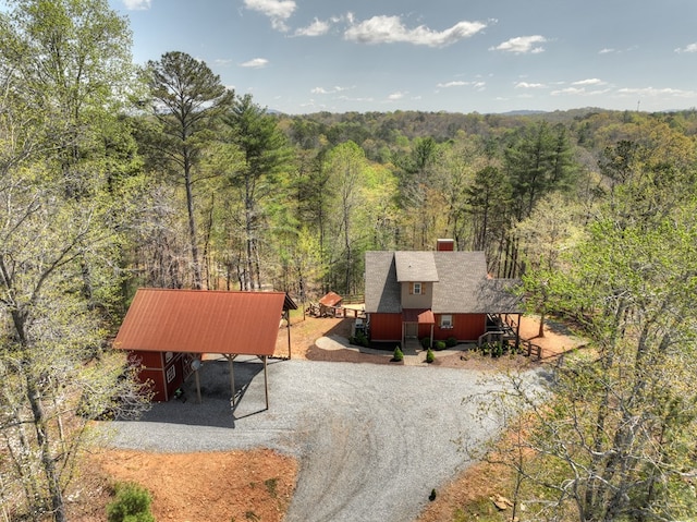 drone / aerial view with a wooded view