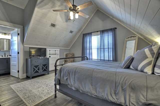 bedroom featuring visible vents, a sink, dark wood finished floors, and lofted ceiling