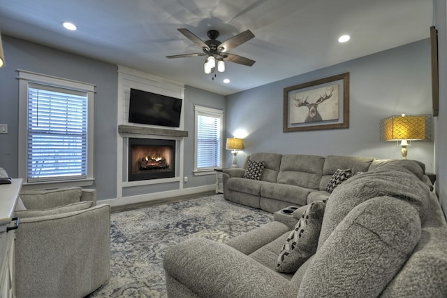 living room with baseboards, ceiling fan, recessed lighting, wood finished floors, and a large fireplace