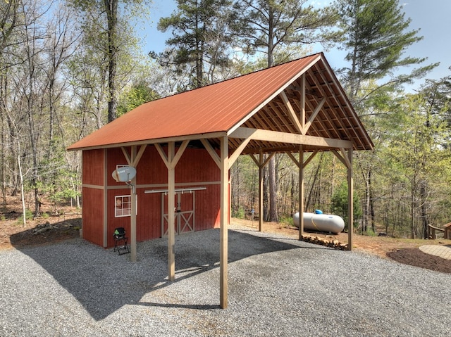 view of community featuring a carport and an outdoor structure