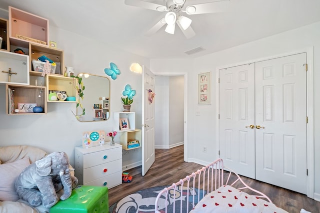 bedroom featuring a closet, wood finished floors, a ceiling fan, and baseboards