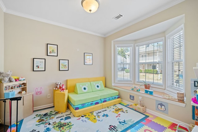 recreation room with baseboards, visible vents, and crown molding