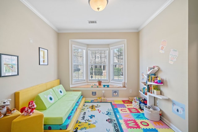 recreation room featuring baseboards, visible vents, and crown molding