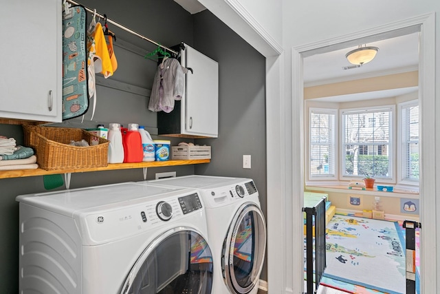 laundry room with ornamental molding, cabinet space, independent washer and dryer, and visible vents