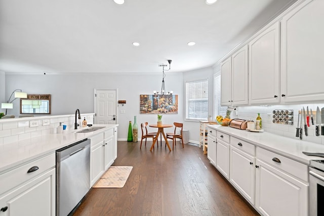 kitchen featuring a sink, white cabinetry, decorative backsplash, and stainless steel dishwasher