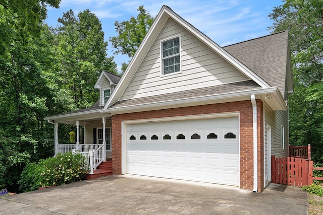 220 Oak Ridge Ln, Ellijay, GA 30536 - view of front of home featuring a porch, brick siding, concrete driveway, a shingled roof, and a garage