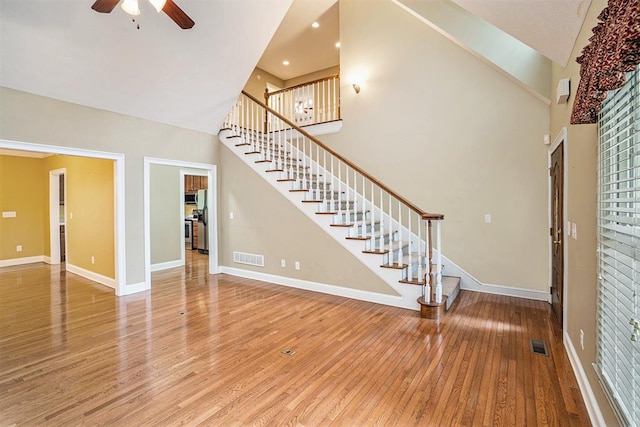 220 Oak Ridge Ln, Ellijay, GA 30536 - unfurnished living room featuring stairway, wood-type flooring, a ceiling fan, a towering ceiling, and recessed lighting