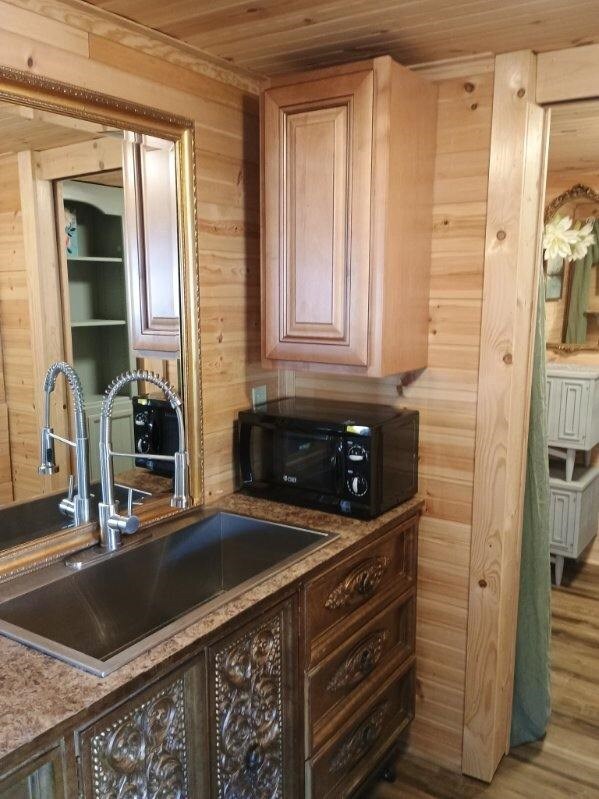 4334 River Bank Run, Hiawassee, GA 30546 - kitchen featuring black microwave, a sink, wooden ceiling, and wooden walls