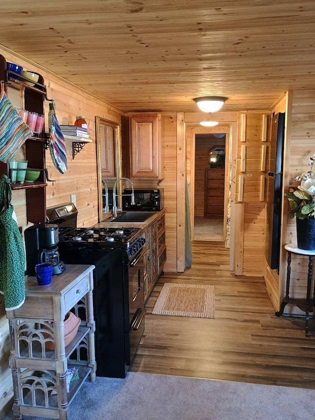 4334 River Bank Run, Hiawassee, GA 30546 - kitchen with black range with gas stovetop, wood ceiling, wooden walls, a sink, and light wood-style flooring