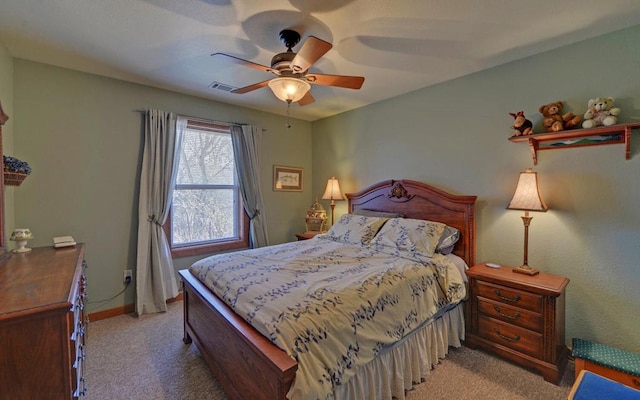 bedroom featuring baseboards, a ceiling fan, visible vents, and light colored carpet