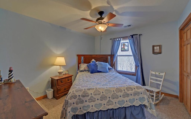 bedroom with light colored carpet, visible vents, ceiling fan, and baseboards