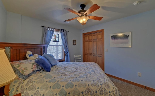 carpeted bedroom with a ceiling fan, baseboards, and a closet