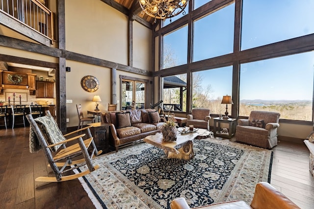 living room featuring plenty of natural light, dark wood-type flooring, and a chandelier