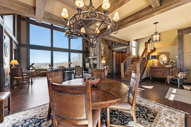 dining room featuring a chandelier, beam ceiling, stairway, and wood-type flooring