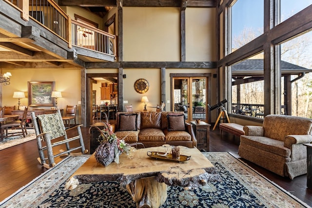 living area with a high ceiling and hardwood / wood-style floors