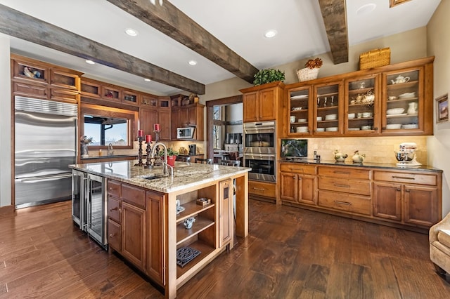 kitchen featuring a sink, stainless steel appliances, wine cooler, and brown cabinets