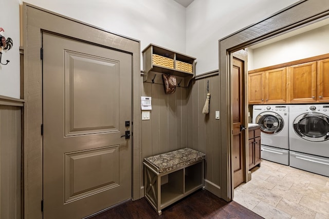 laundry room with washer and clothes dryer and cabinet space