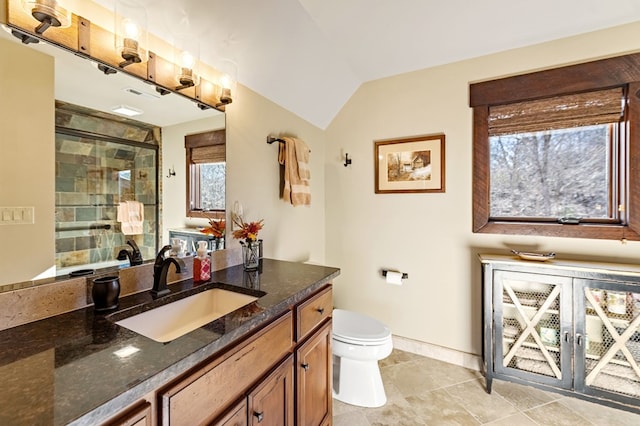 full bathroom featuring toilet, a stall shower, baseboards, vanity, and vaulted ceiling