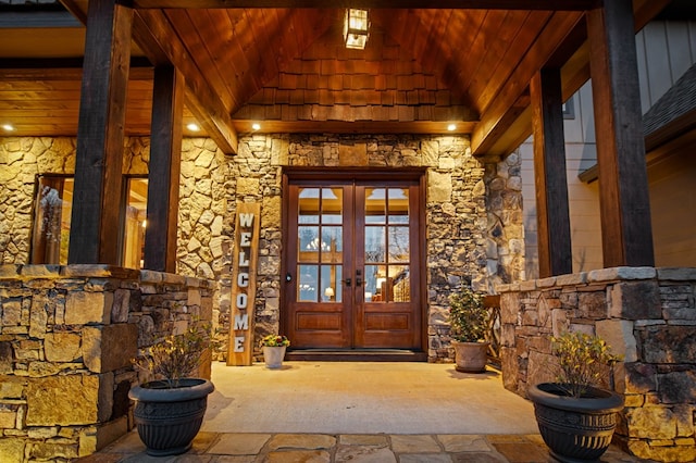 doorway to property featuring french doors and stone siding