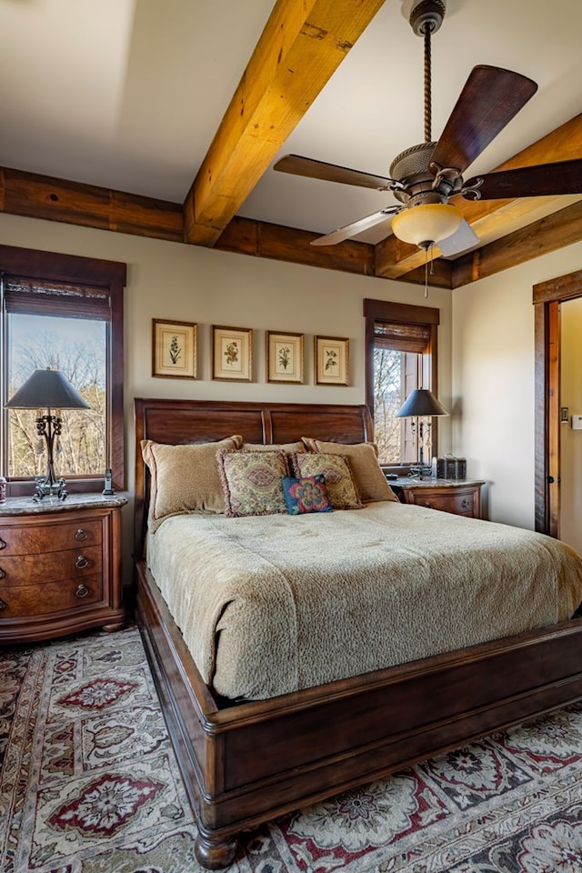 bedroom featuring beam ceiling and a ceiling fan