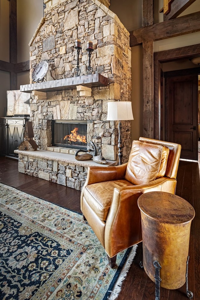 living area with a fireplace and wood-type flooring