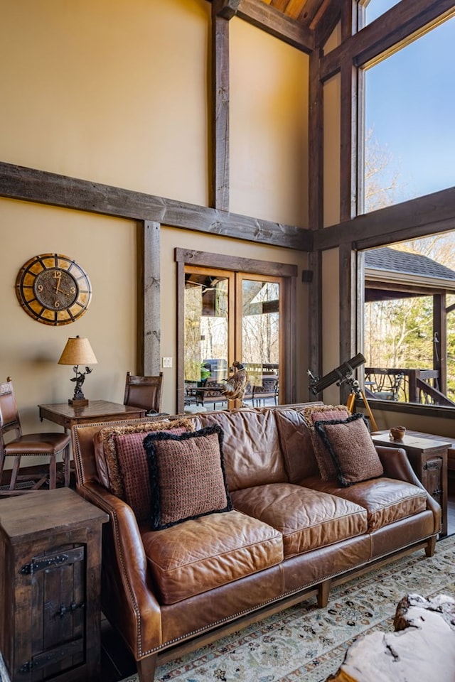 living room with french doors and a towering ceiling