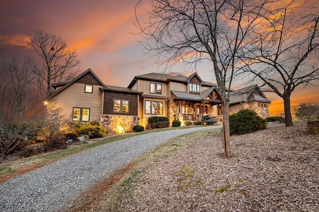 view of front of house featuring stone siding and driveway