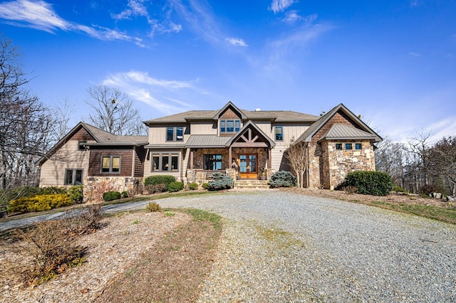 view of front of home featuring stone siding, curved driveway, board and batten siding, and french doors