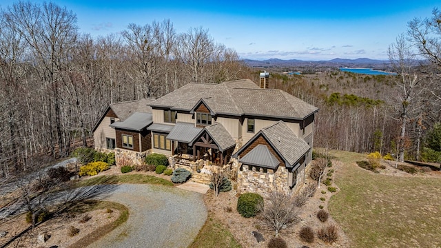 view of front facade with stone siding and driveway