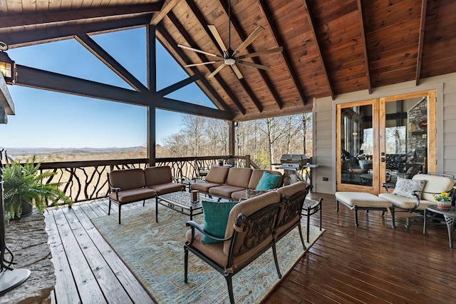 wooden terrace with an outdoor living space, a ceiling fan, a mountain view, and a grill