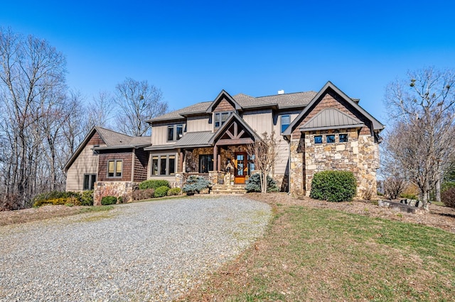 craftsman inspired home with board and batten siding, a front lawn, and stone siding