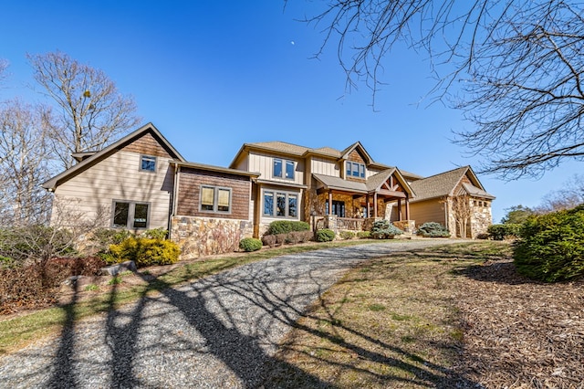 view of front of home featuring stone siding and covered porch