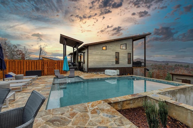 view of pool featuring a patio, a fenced in pool, and fence