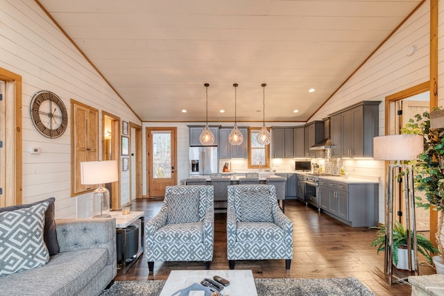 living room featuring recessed lighting, wood walls, lofted ceiling, and dark wood-style floors