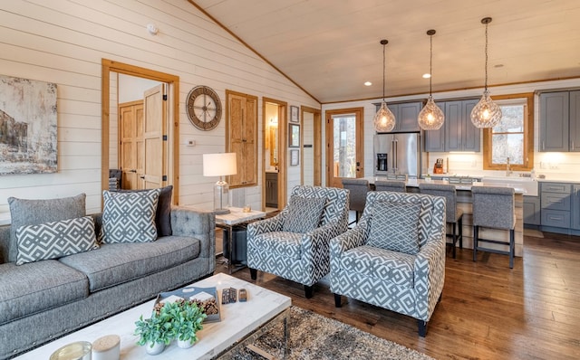 living room featuring wooden walls, lofted ceiling, and dark wood-type flooring