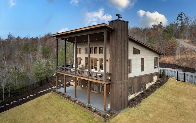 view of outbuilding with a forest view and a fenced backyard