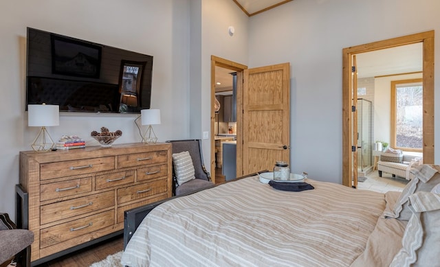 bedroom featuring a high ceiling and ensuite bath
