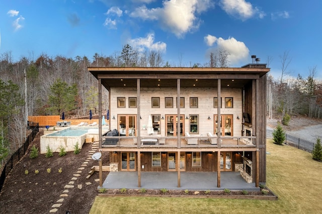 back of property featuring fence, a fenced in pool, french doors, and a patio area