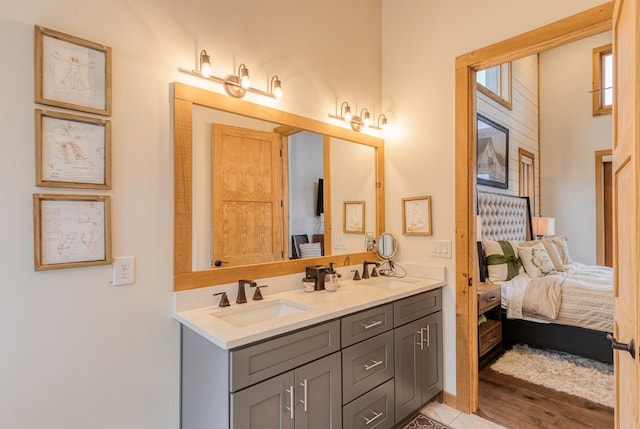 bathroom with double vanity, a sink, and ensuite bathroom