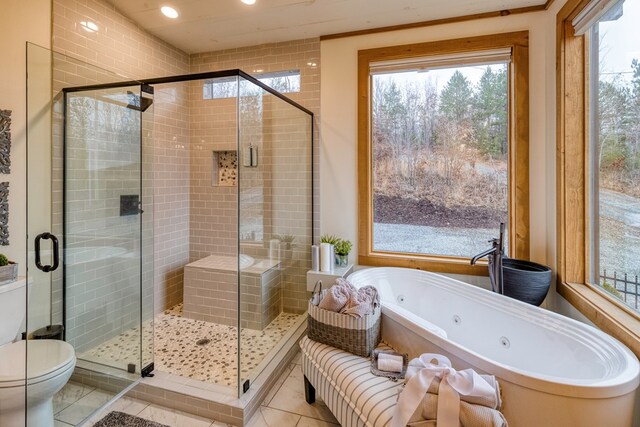 full bath with a whirlpool tub, tile patterned floors, toilet, and a stall shower