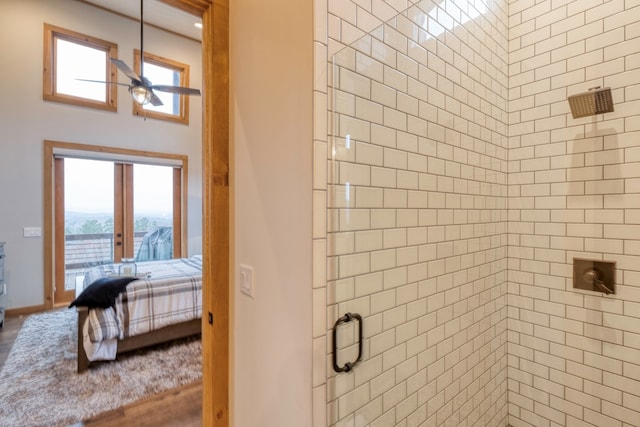 full bath featuring ceiling fan, plenty of natural light, tiled shower, and ensuite bath