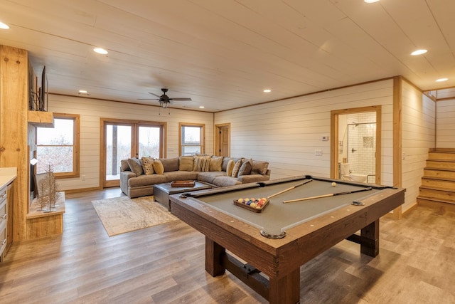 rec room featuring wood walls, light wood-style flooring, a ceiling fan, and pool table