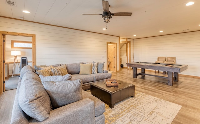 living room featuring wooden walls, recessed lighting, and wood finished floors