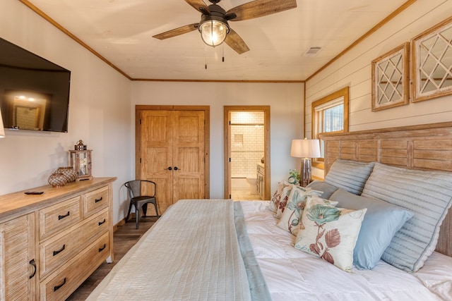 bedroom featuring visible vents, ornamental molding, ensuite bathroom, and a closet