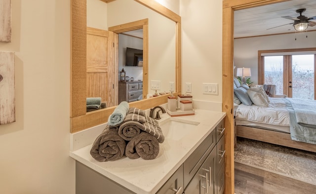 bathroom featuring french doors, a ceiling fan, wood finished floors, vanity, and ensuite bath